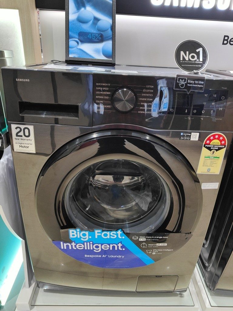 Front view of Samsung 9 kg 5‑star front‑load washing machine (WW90DG5U24AXTL) showing the program dial and LED touch display panel