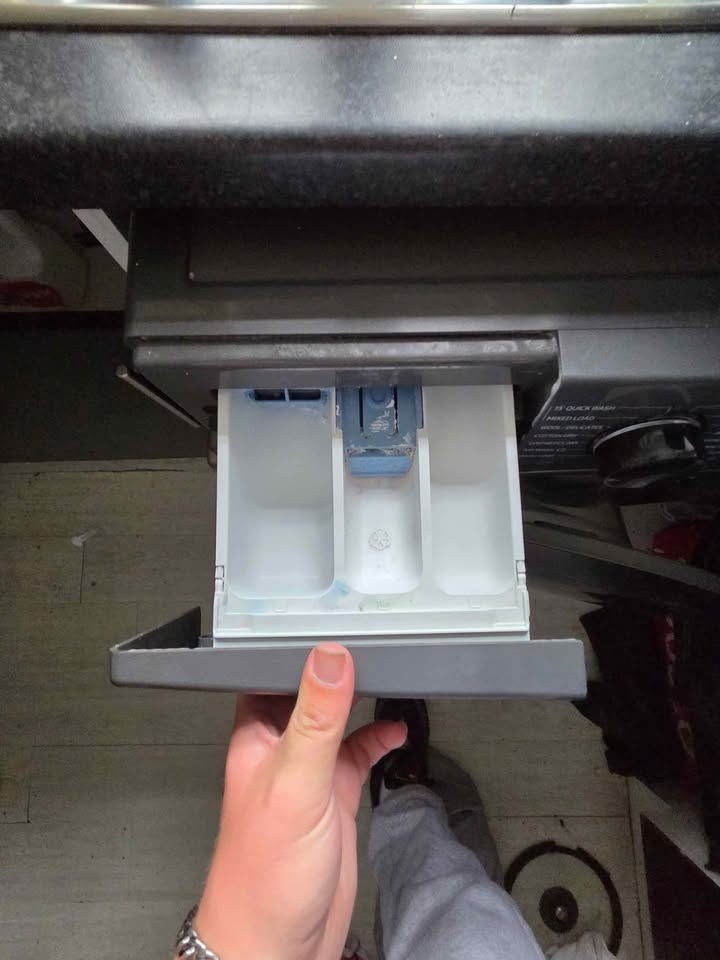 Close-up view of the detergent drawer of a Samsung 12 kg (Wash)  7 kg (Dry) Front Load Washer Dryer (WD12FG5B34BBTL), pulled open to show its three detergent and softener compartments