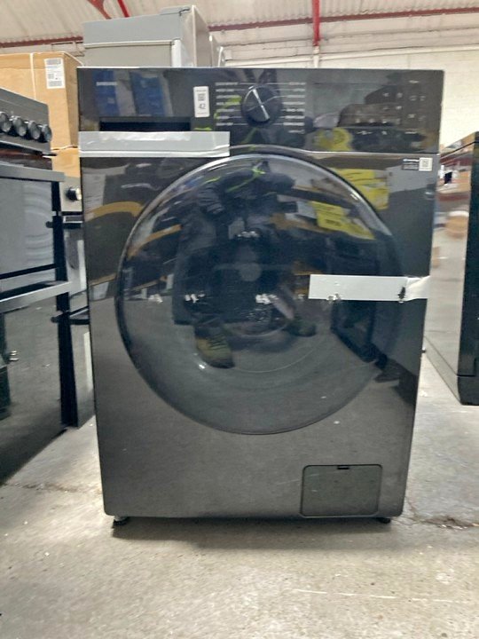 Samsung WD12FG5B34BBTL front load washer dryer with 12 kg wash capacity and 7 kg dry capacity, shown in black finish in a warehouse setting