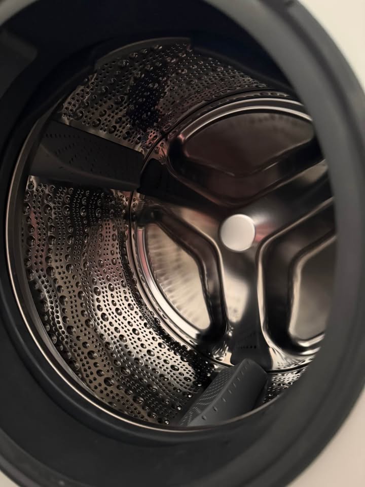 Close-up view of the stainless steel drum interior of a Bosch 10.5/6 KG front load washer dryer (WNA2E4U1IN)