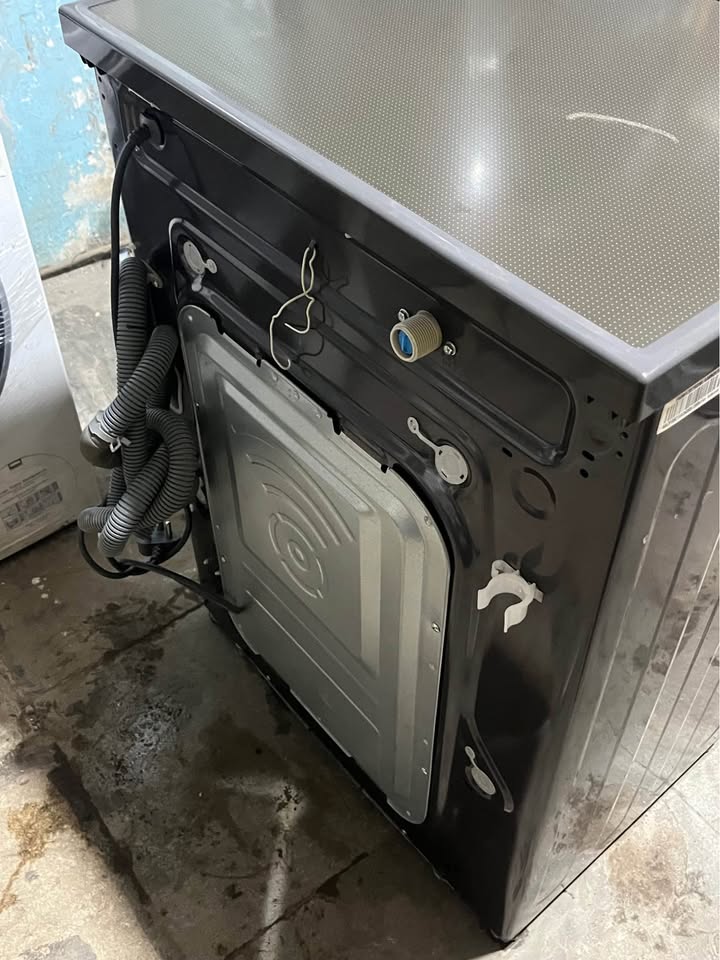 LG FHB1207Z2M washing machine rear panel showing water inlet valve, drain hose, and power cable connections